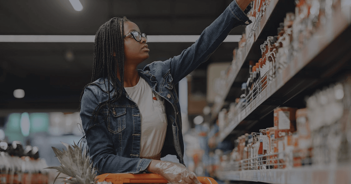 Man walking down aisle in a large warehouse with shelves. - 7 ecommerce automation use cases that actually move revenue