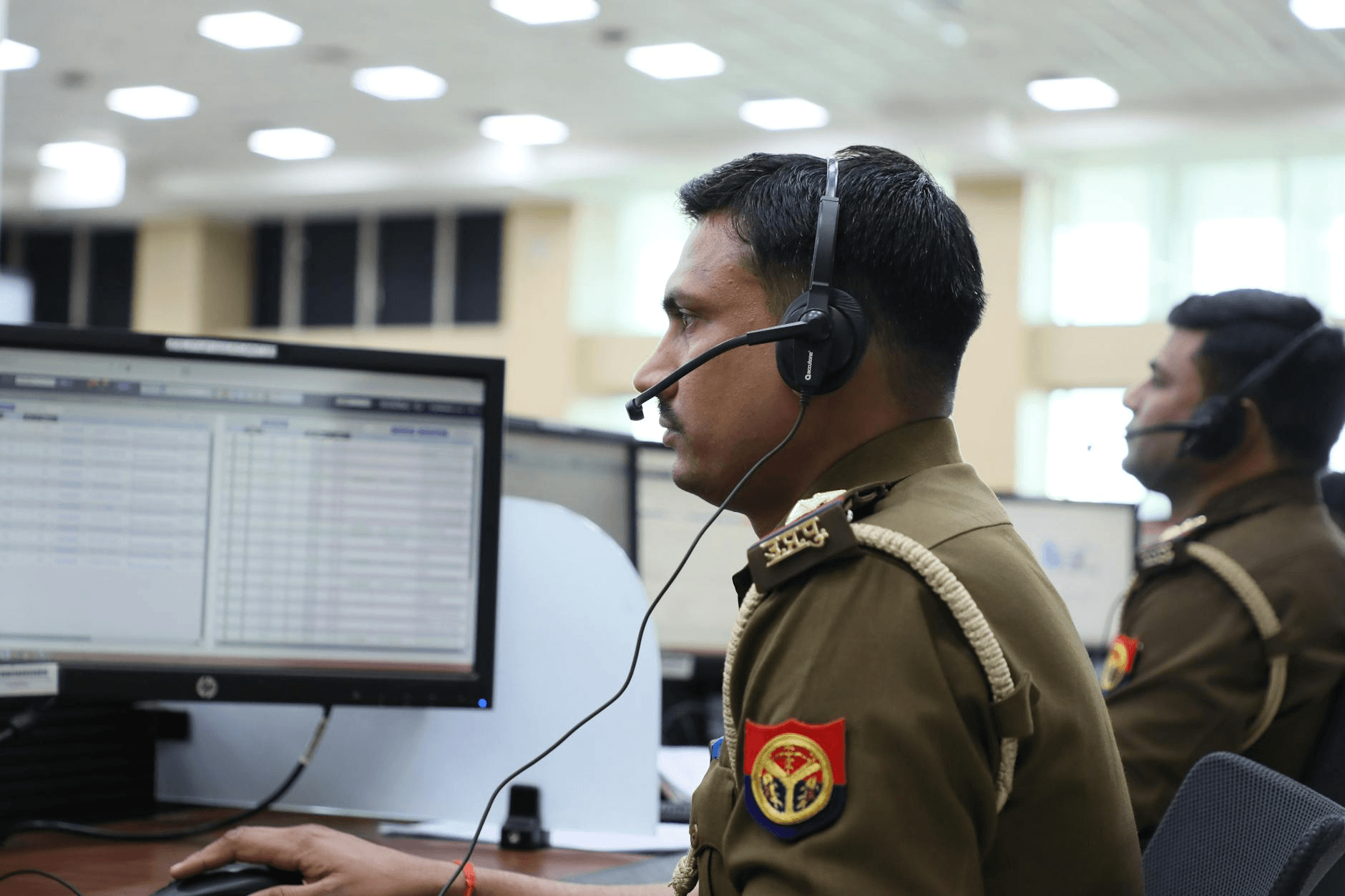 fleet dispatcher monitoring real-time vehicle locations on a multi-screen operations dashboard