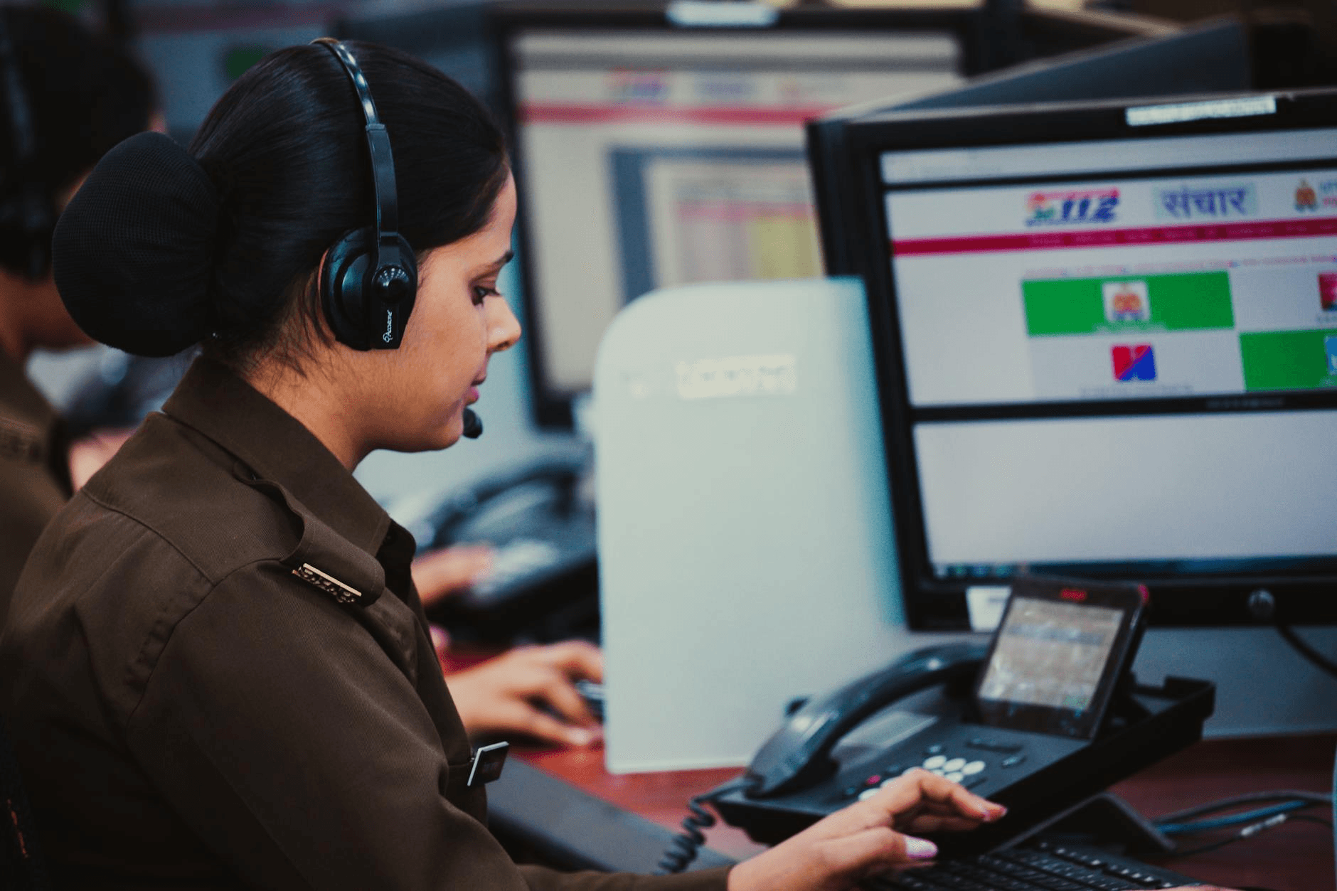 Field service dispatcher reviewing technician job board on desktop computer