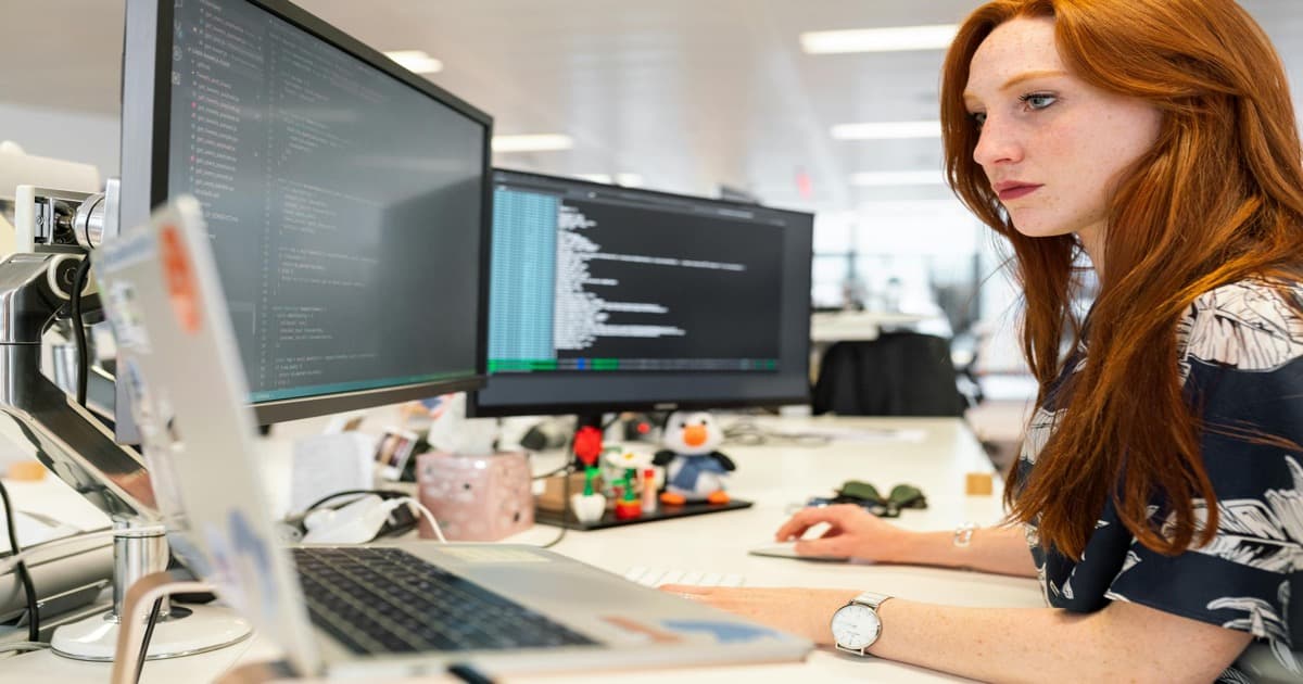product manager reviewing LLM API integration architecture on laptop