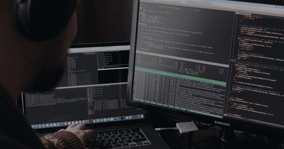Developer using AI coding assistant with code visible on dual monitor setup