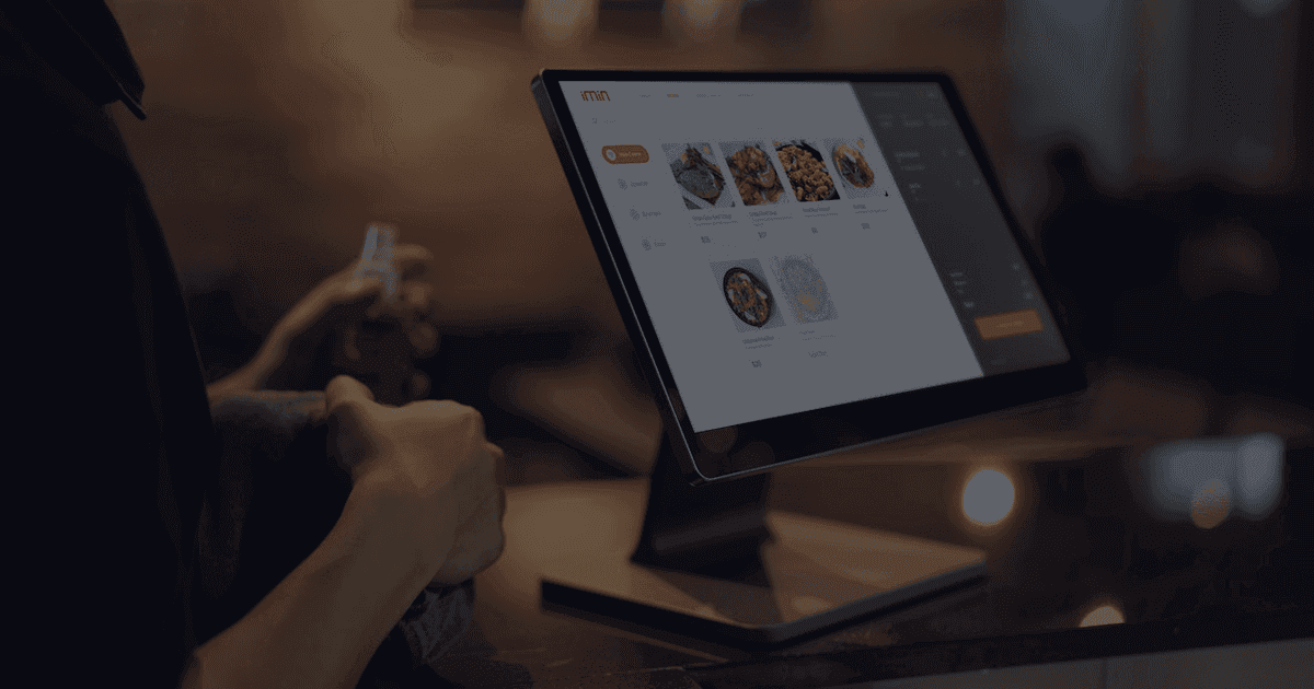 Restaurant staff using a POS ordering system at the counter - voice AI for restaurant phone orders