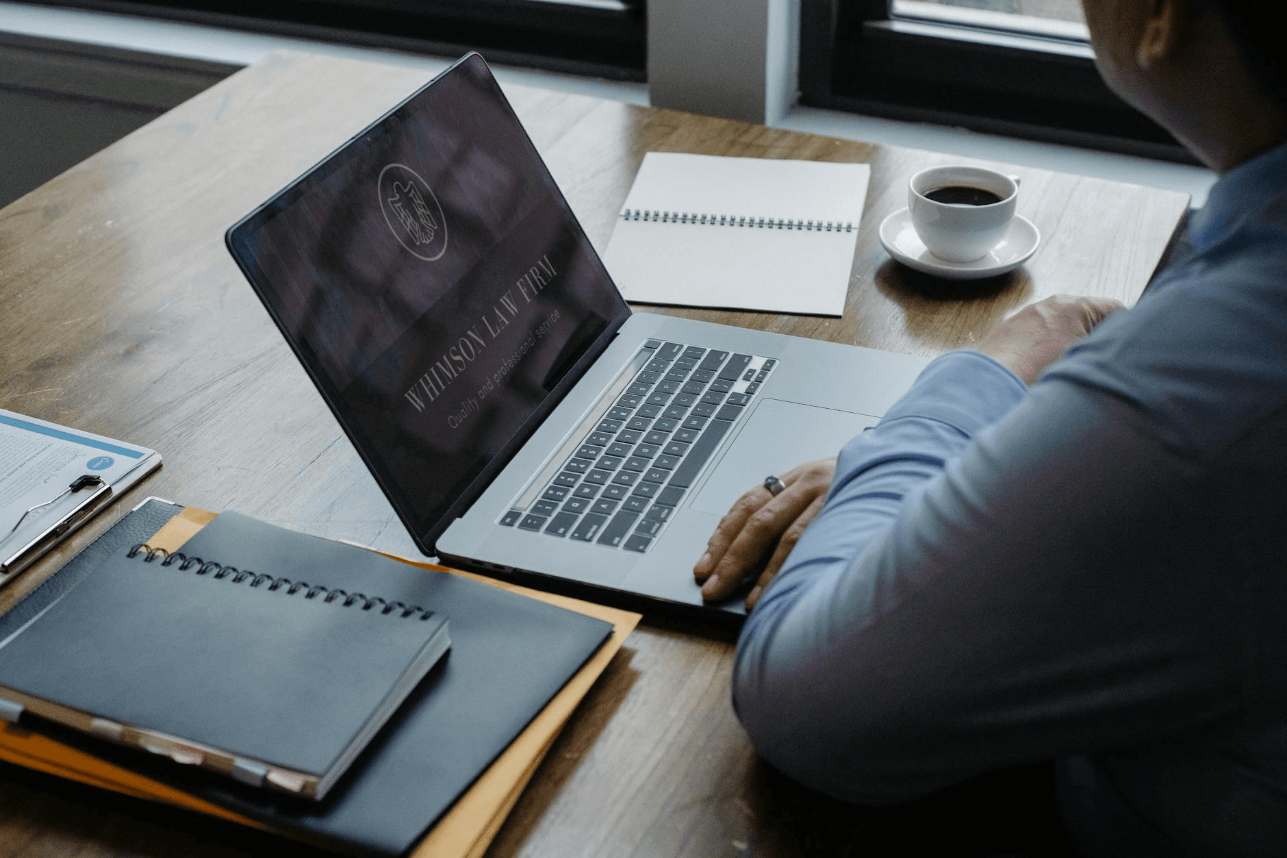 Attorney reviewing legal documents on a laptop in a law office