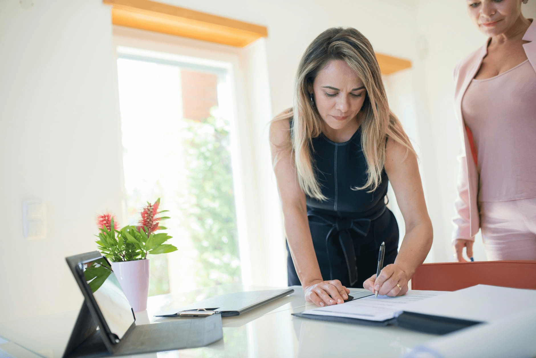 Person signing a document on a tablet with a stylus - how to build an app like DocuSign